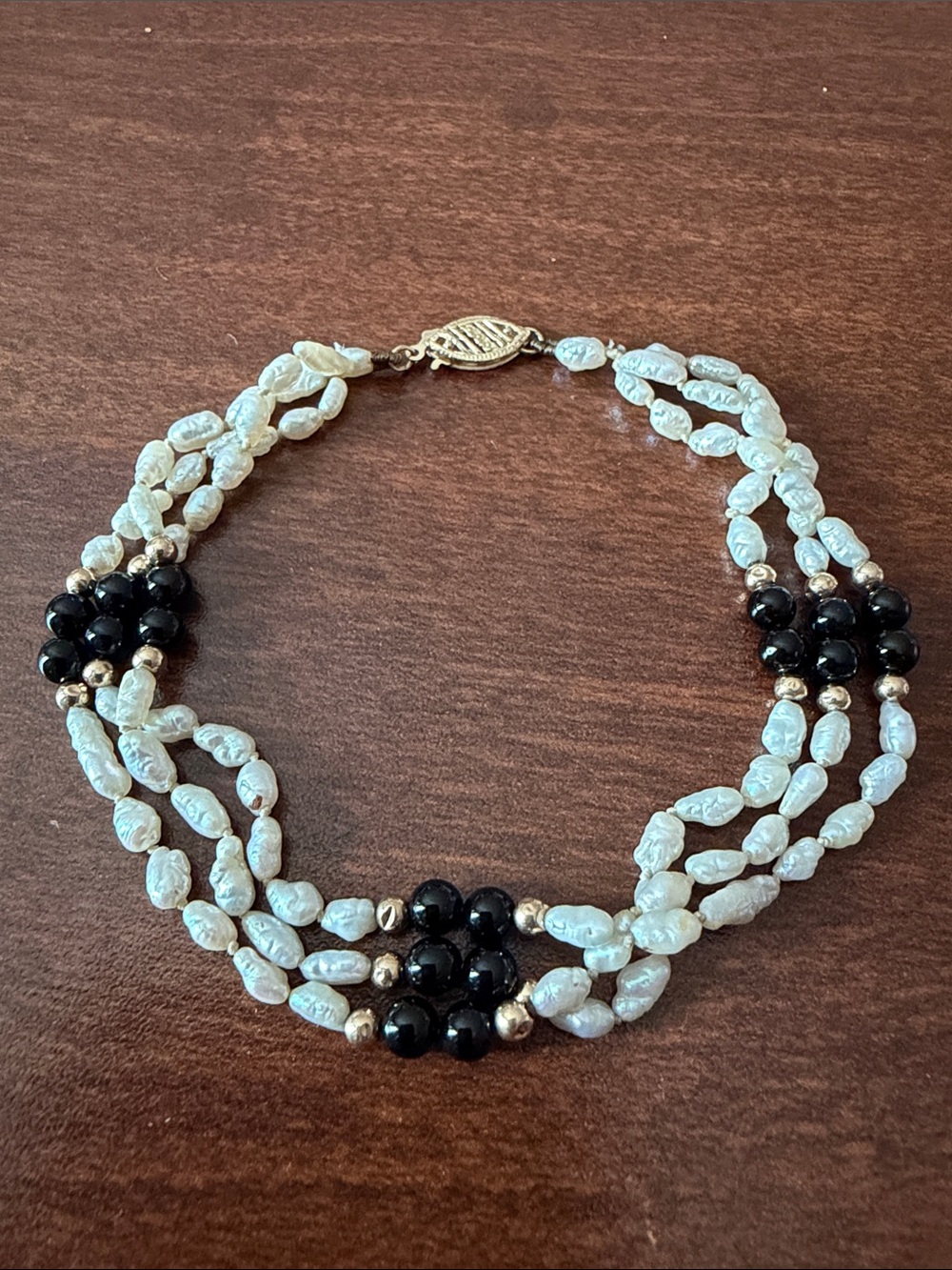 Solid 14K gold multi strand bracelet with river pearls and black onyx
